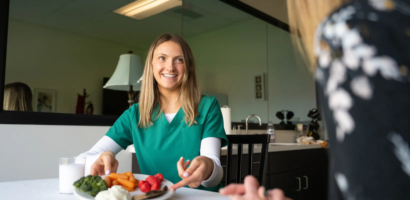 student displaying a plate full of healthy colorful food