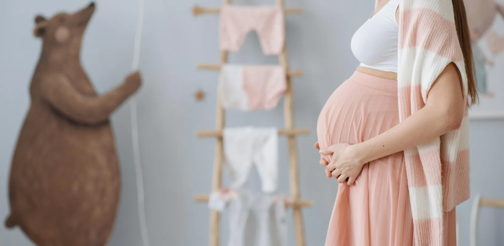 pregnant woman holding her baby bump