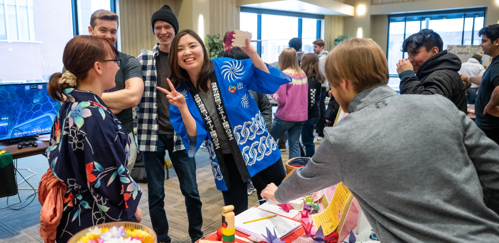 International Student in front of event table