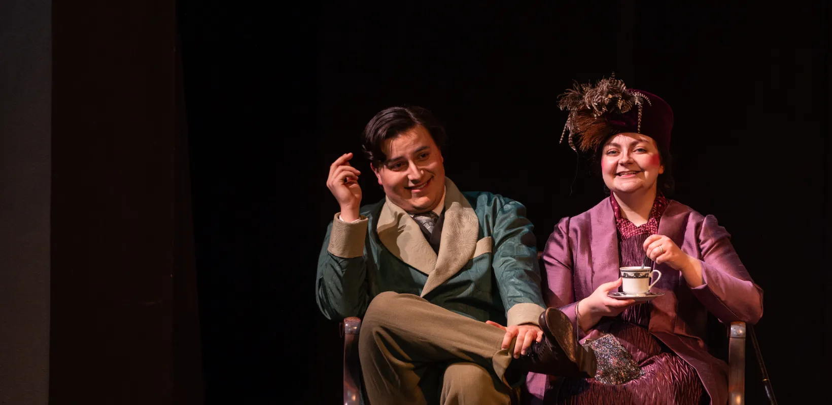 Two student actors, a man and a woman, performing in "The Importance of Being Earnest."