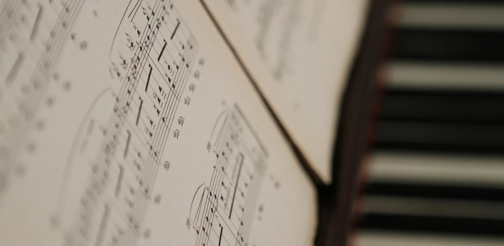 A close up of piano music and keyboard.