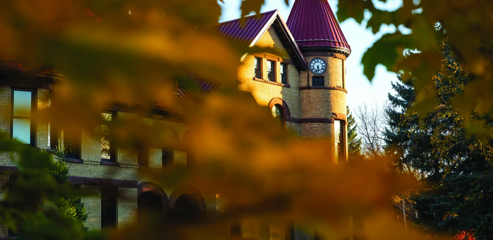 Old Main behind fall trees