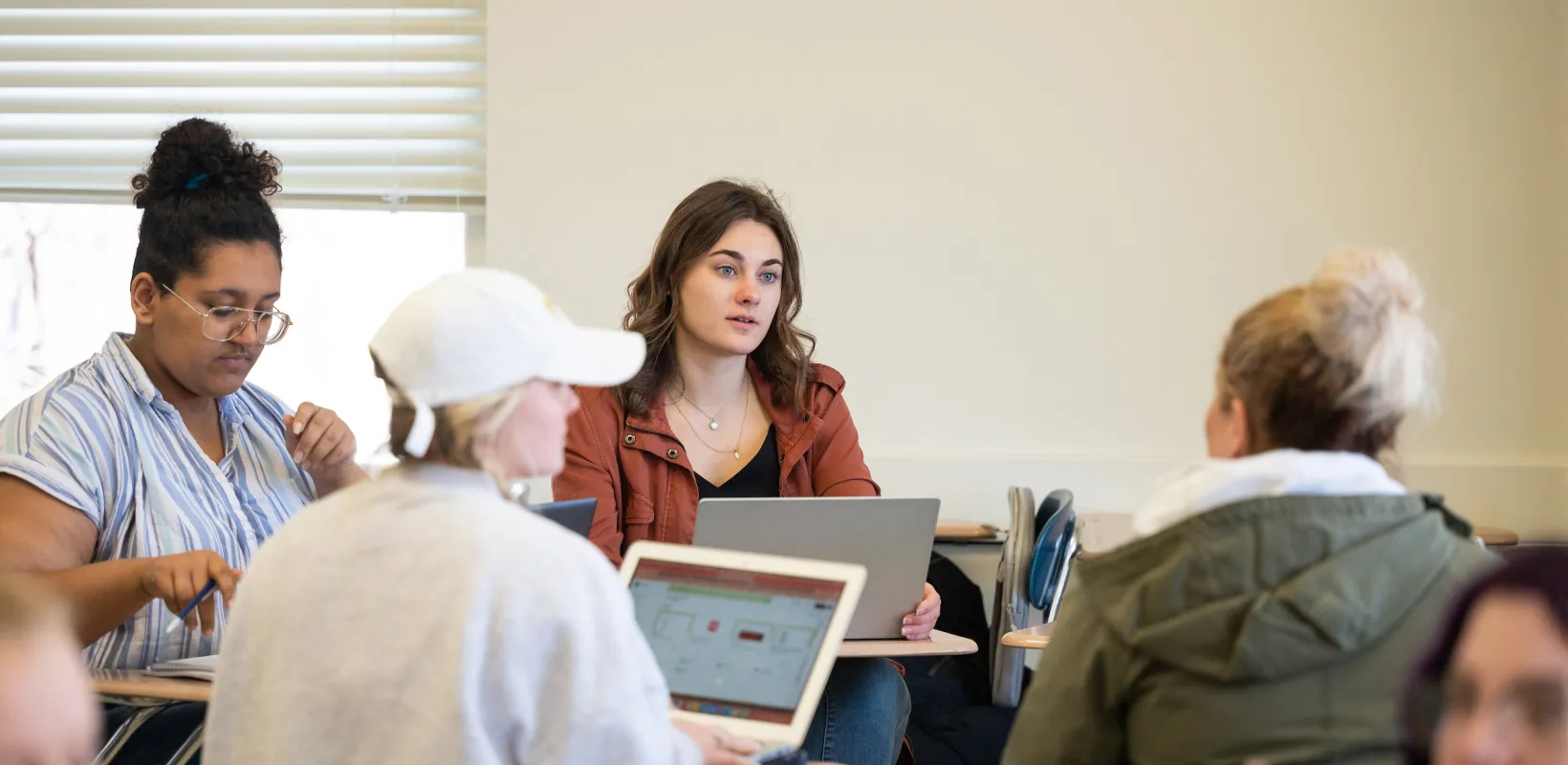 students having a discussion during writing class