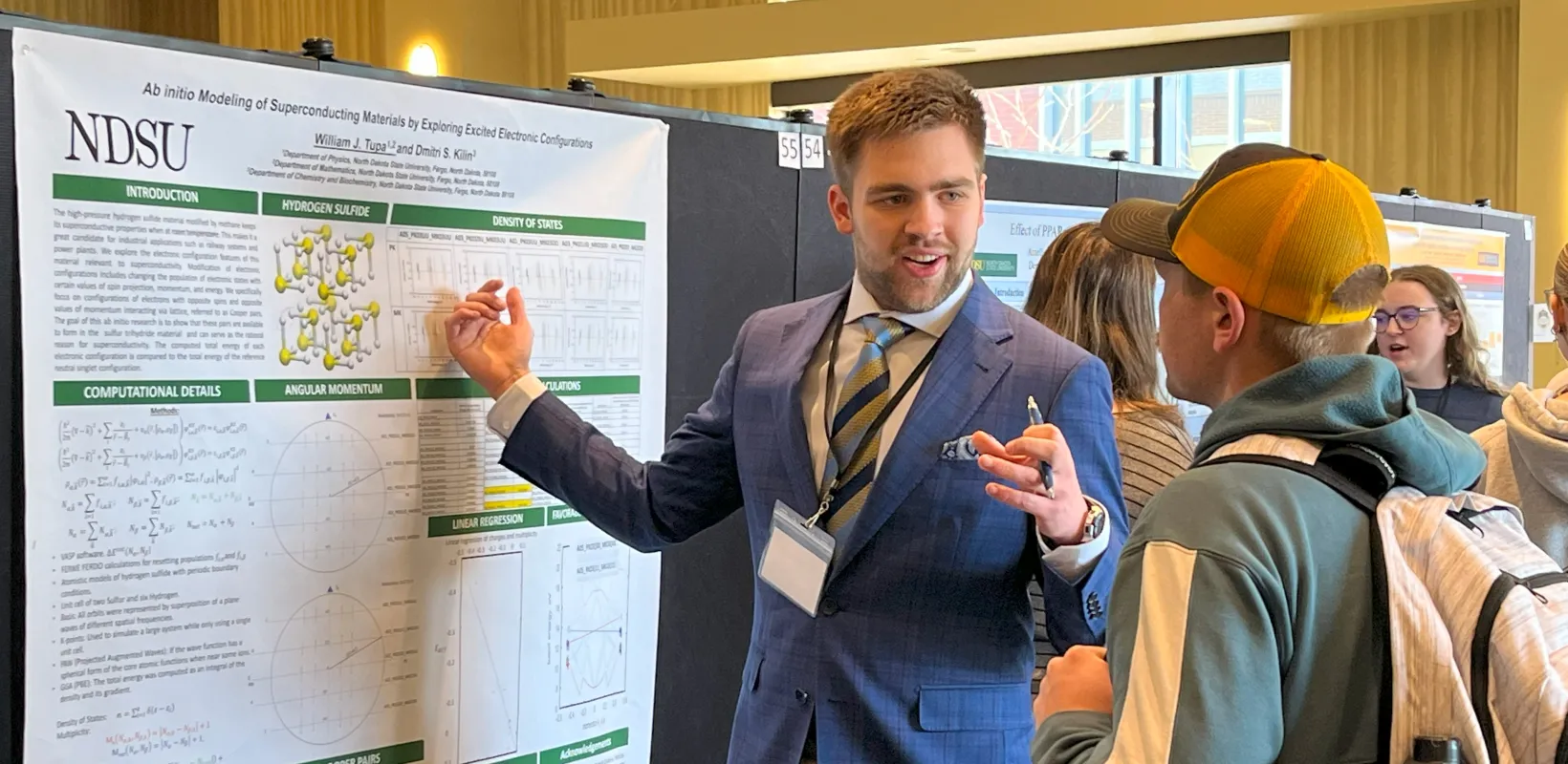 Students discuss a research project during the Student Research Days poster session