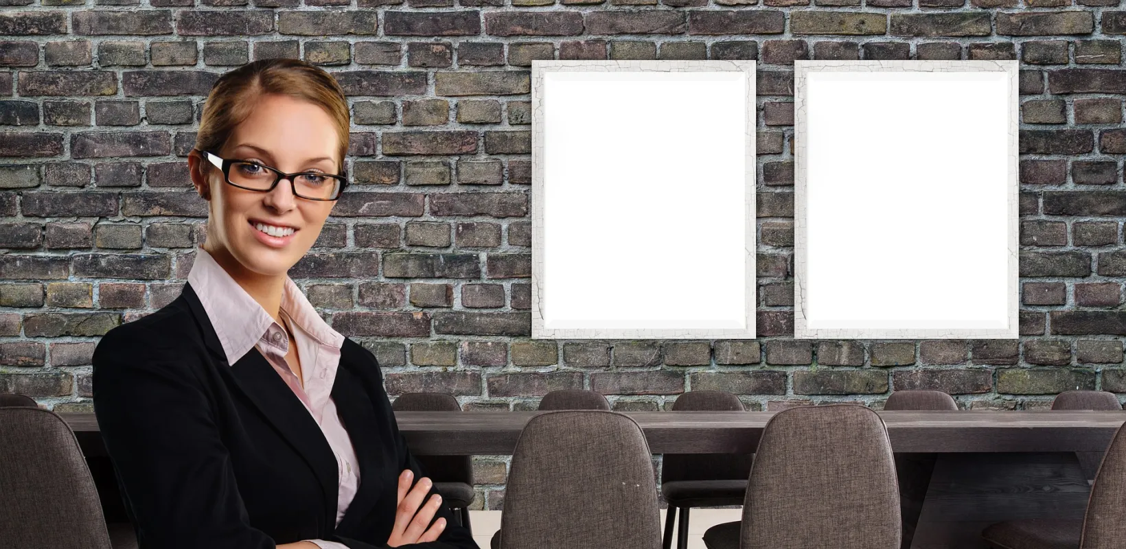 Business woman arms folded in an empty room with a big table and whiteboard