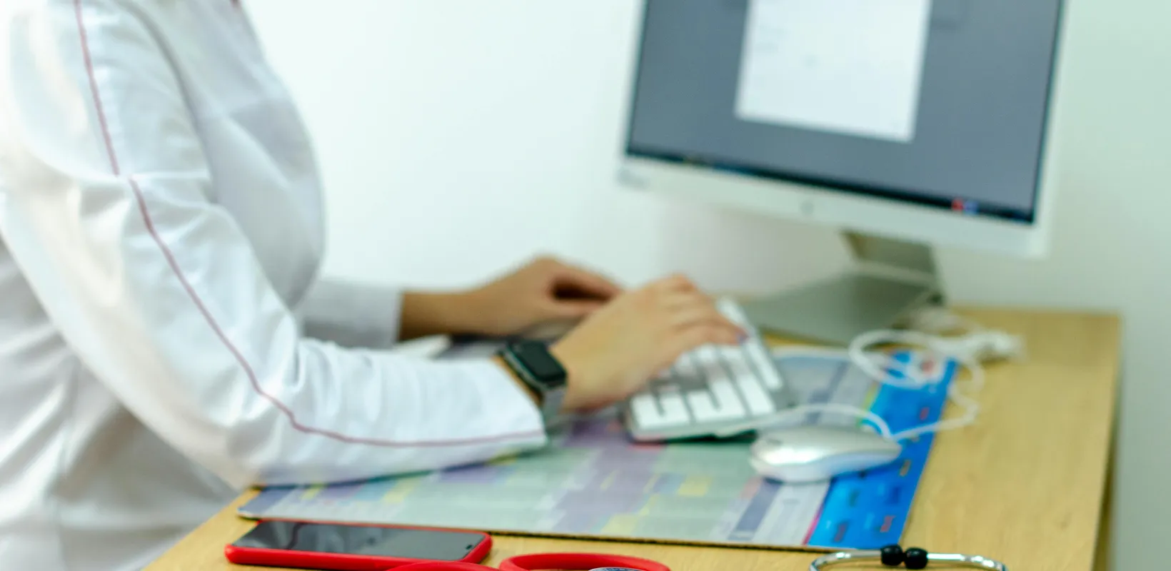 close up of healthcare administrator working on computer