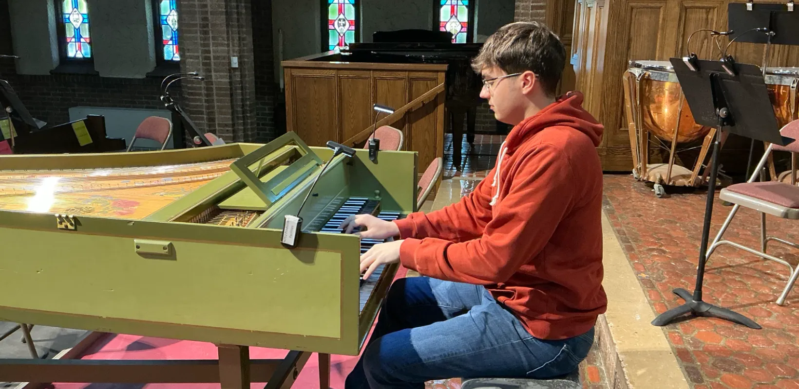 NDSU student Zakk Volk working on the harpsichord