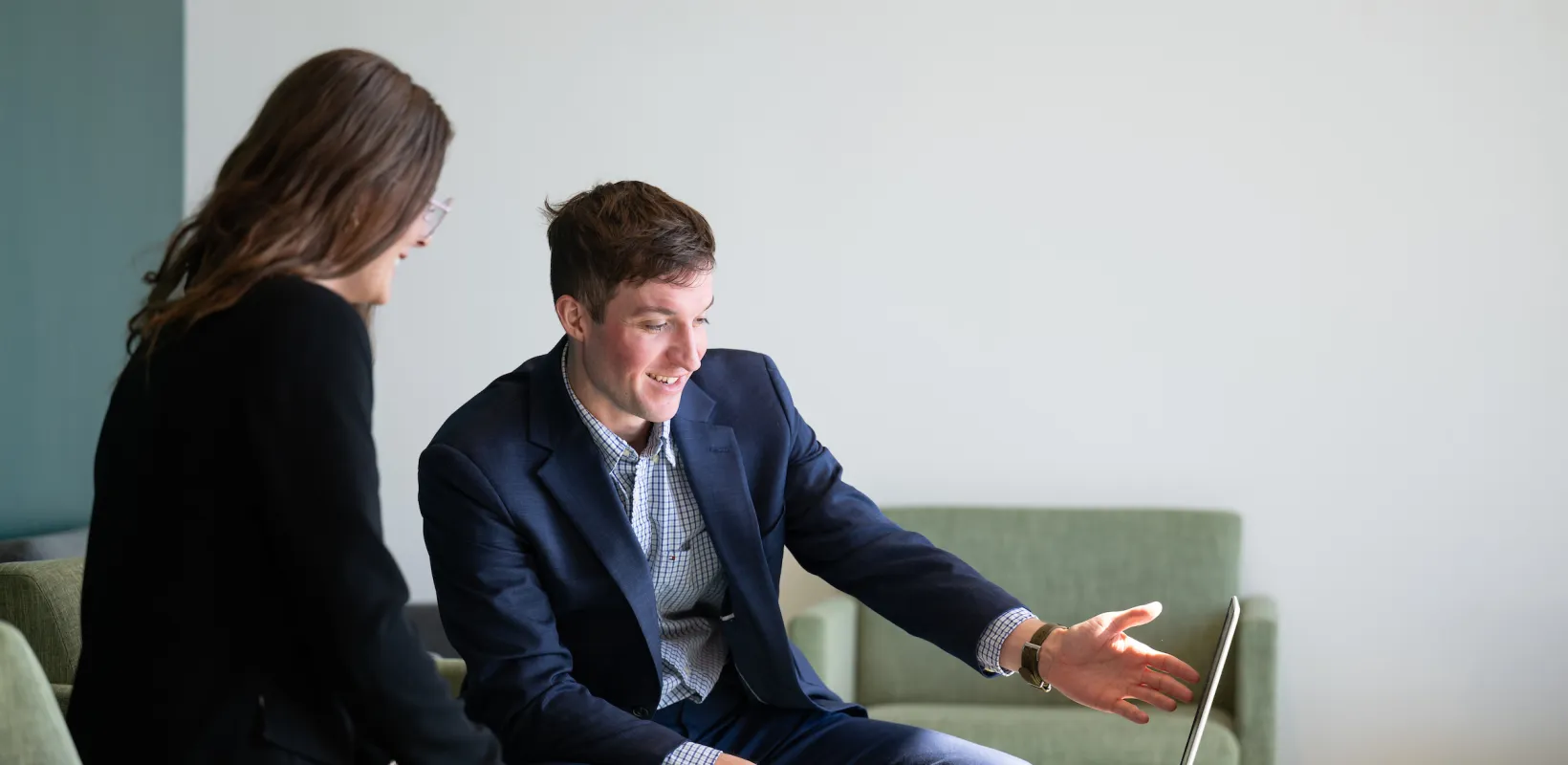 students in Health Services having a discussion and looking at a laptop