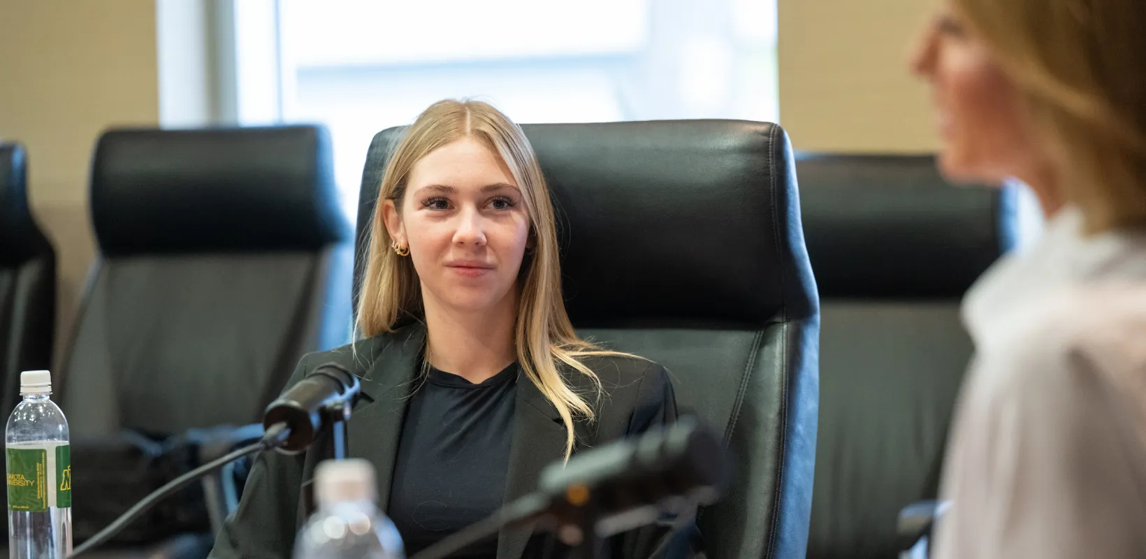 student interviewing an entrepreneur as part of a business podcast