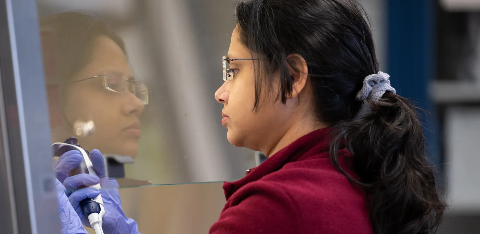 graduate Microbiology student works in a lab