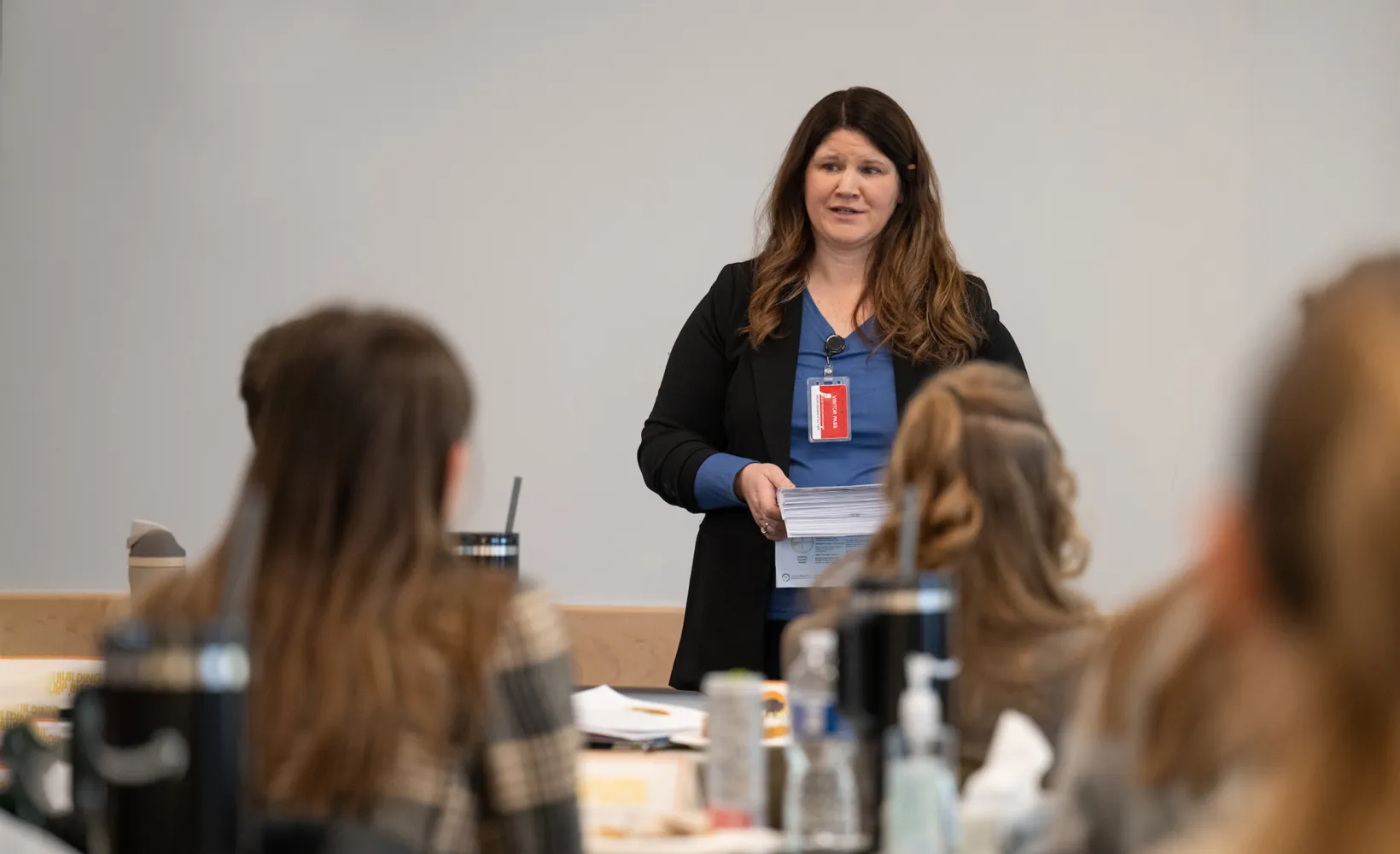 Faculty member in the Management degree program has discussion with students