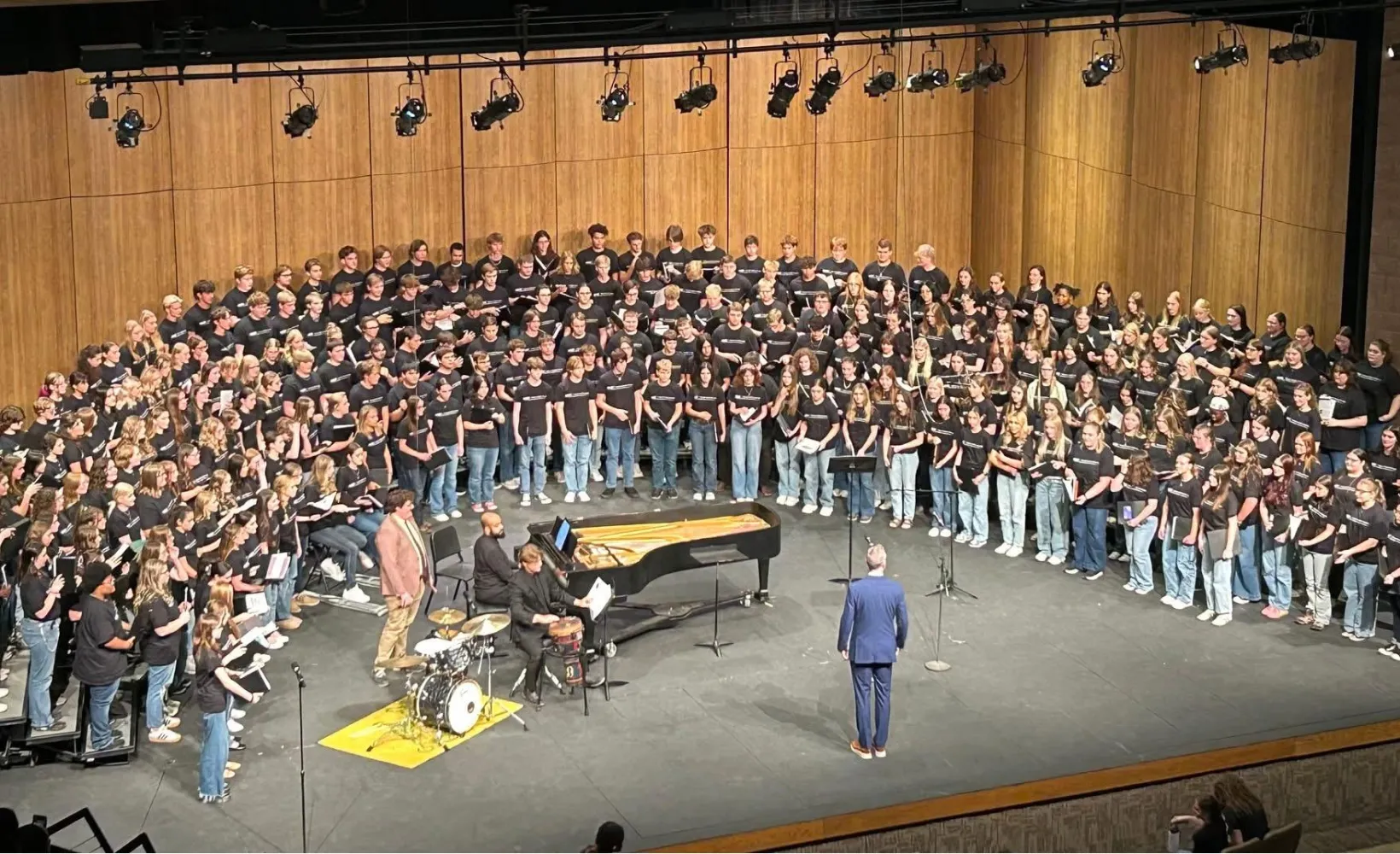 Hundreds of students singing on stage at the 2025 NDSU High School Choral Festival.