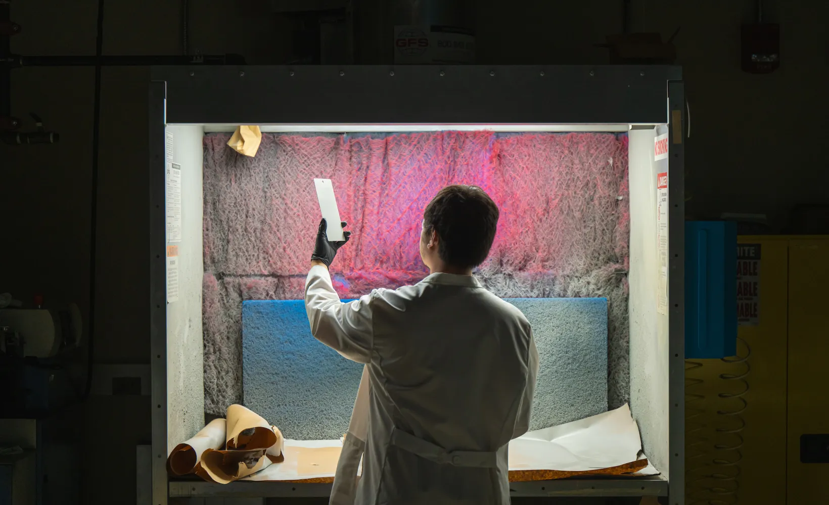 Man holds a polymer up to the light. 
