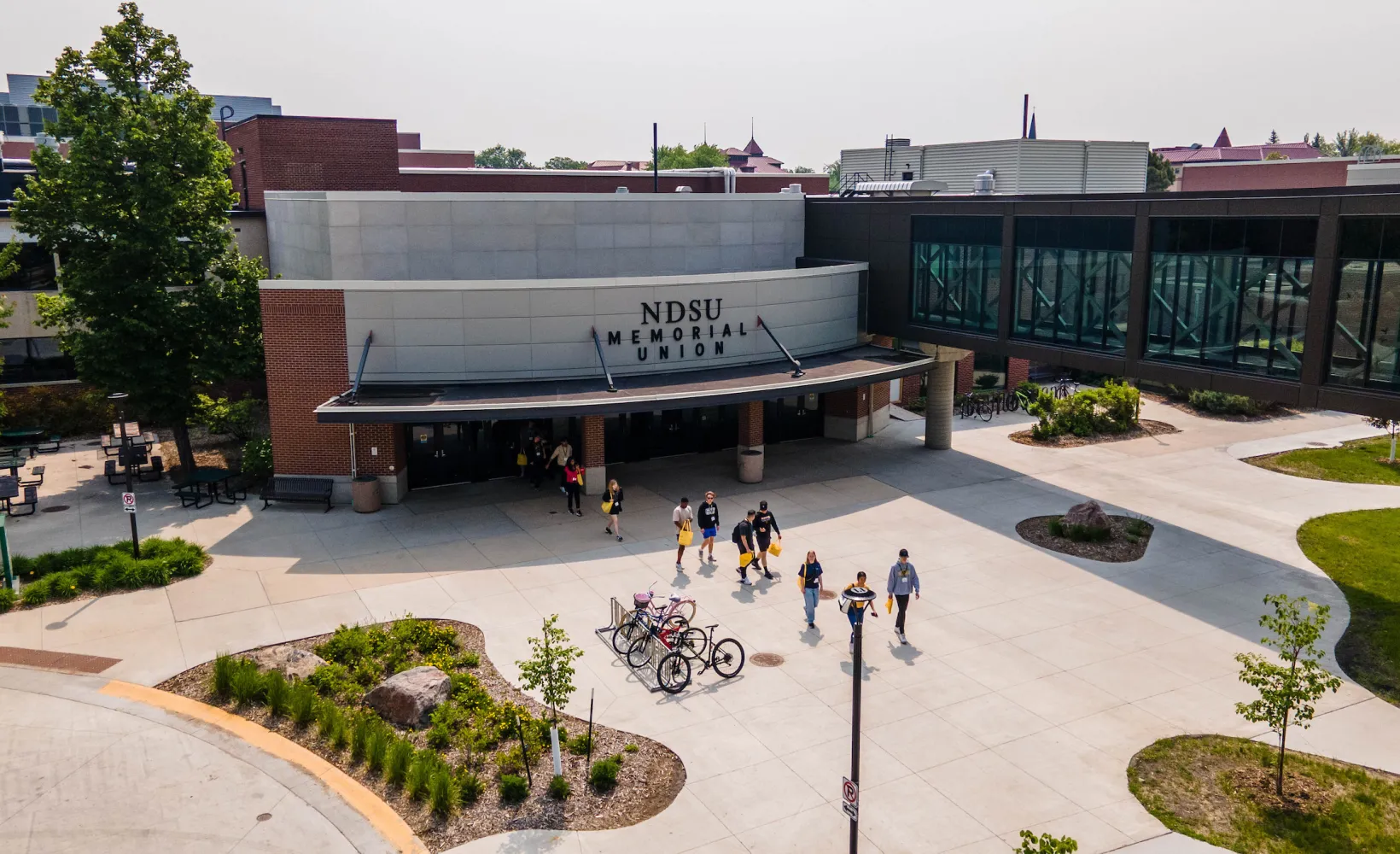 Students walk through a plaza 