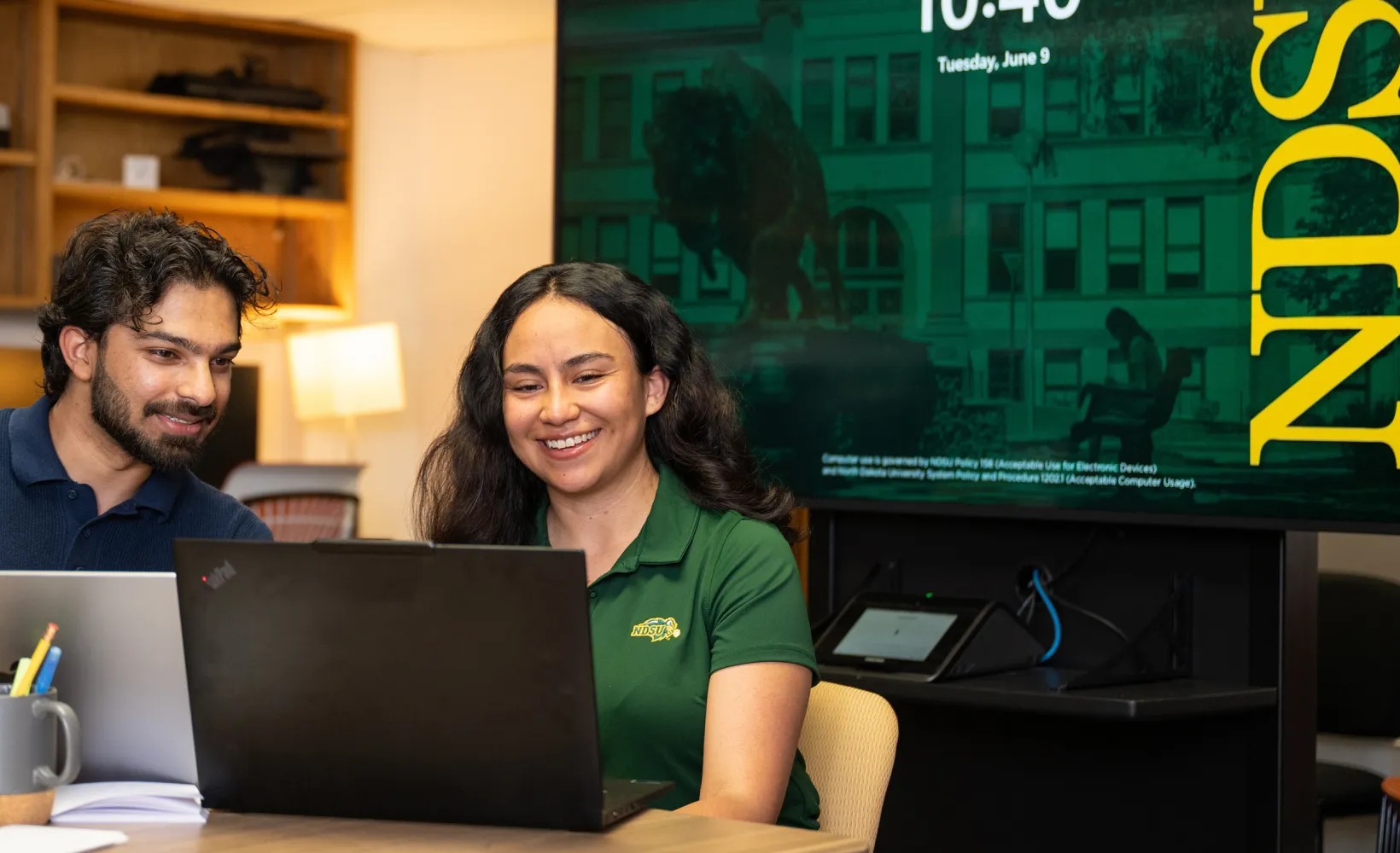 graduate students study together in a campus building