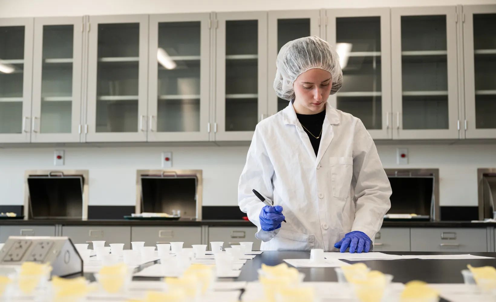 student in Food Science tests food items in the lab