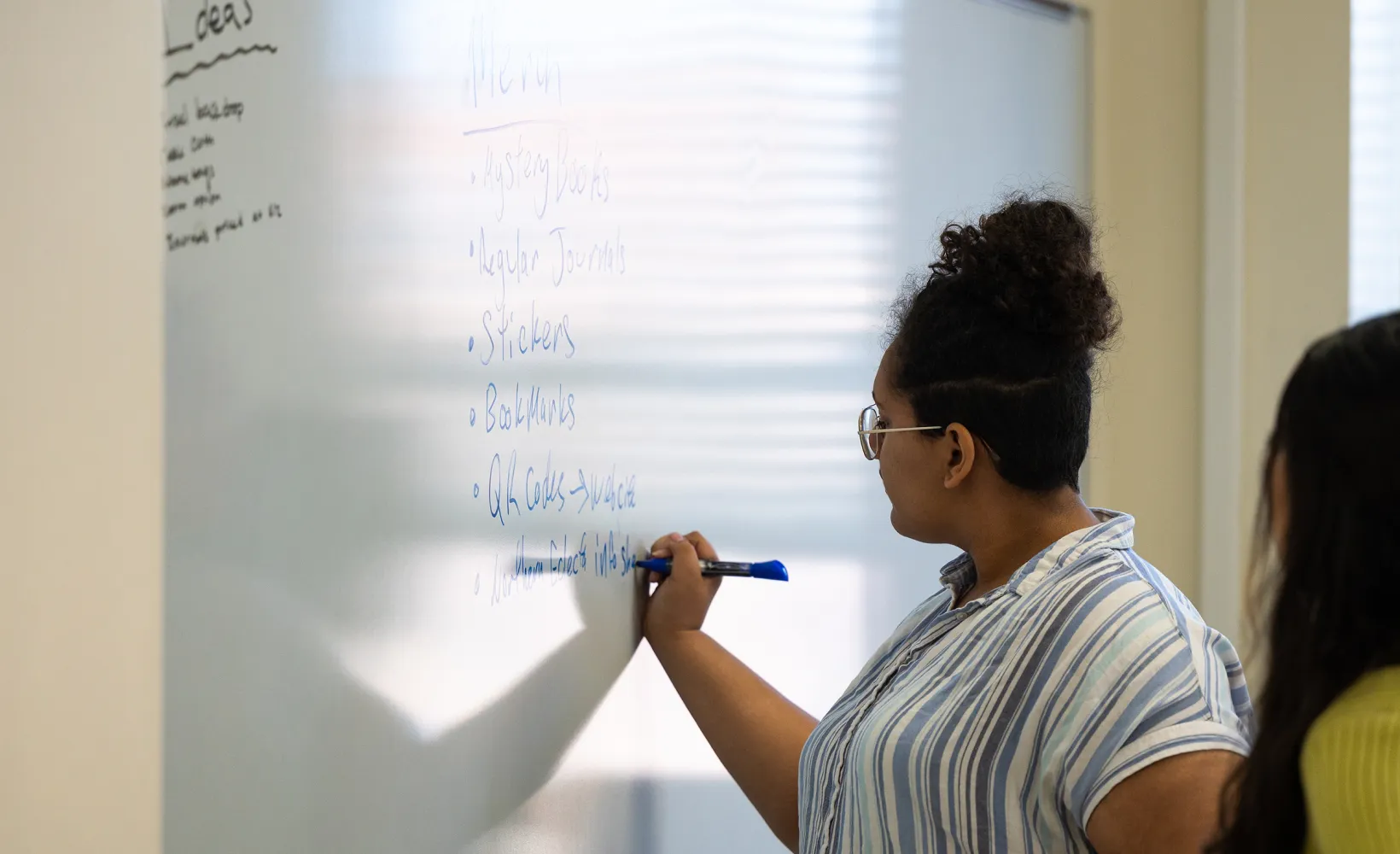 English students writing on the whiteboard during class
