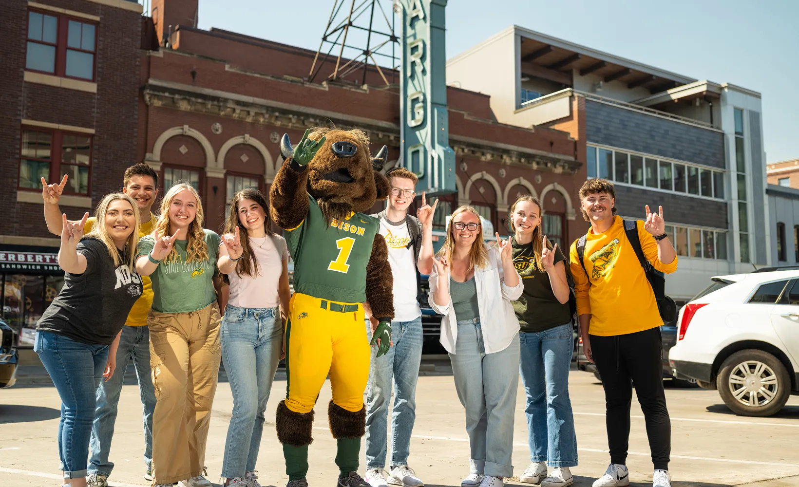 group of NDSU students downtown with Thundar in front of the Fargo theater sign