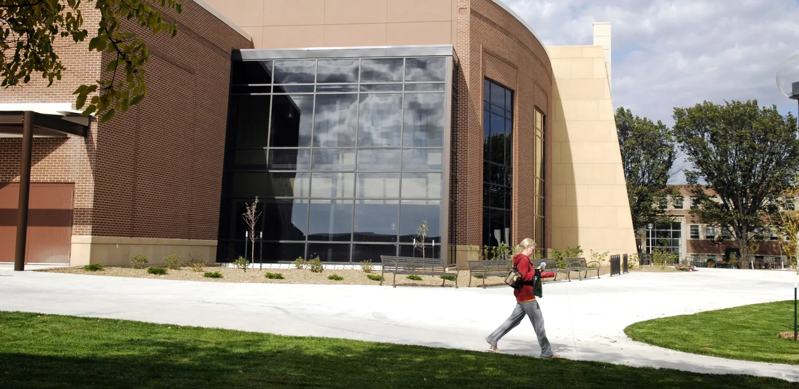 Student walking past exterior windows of Memorial Union