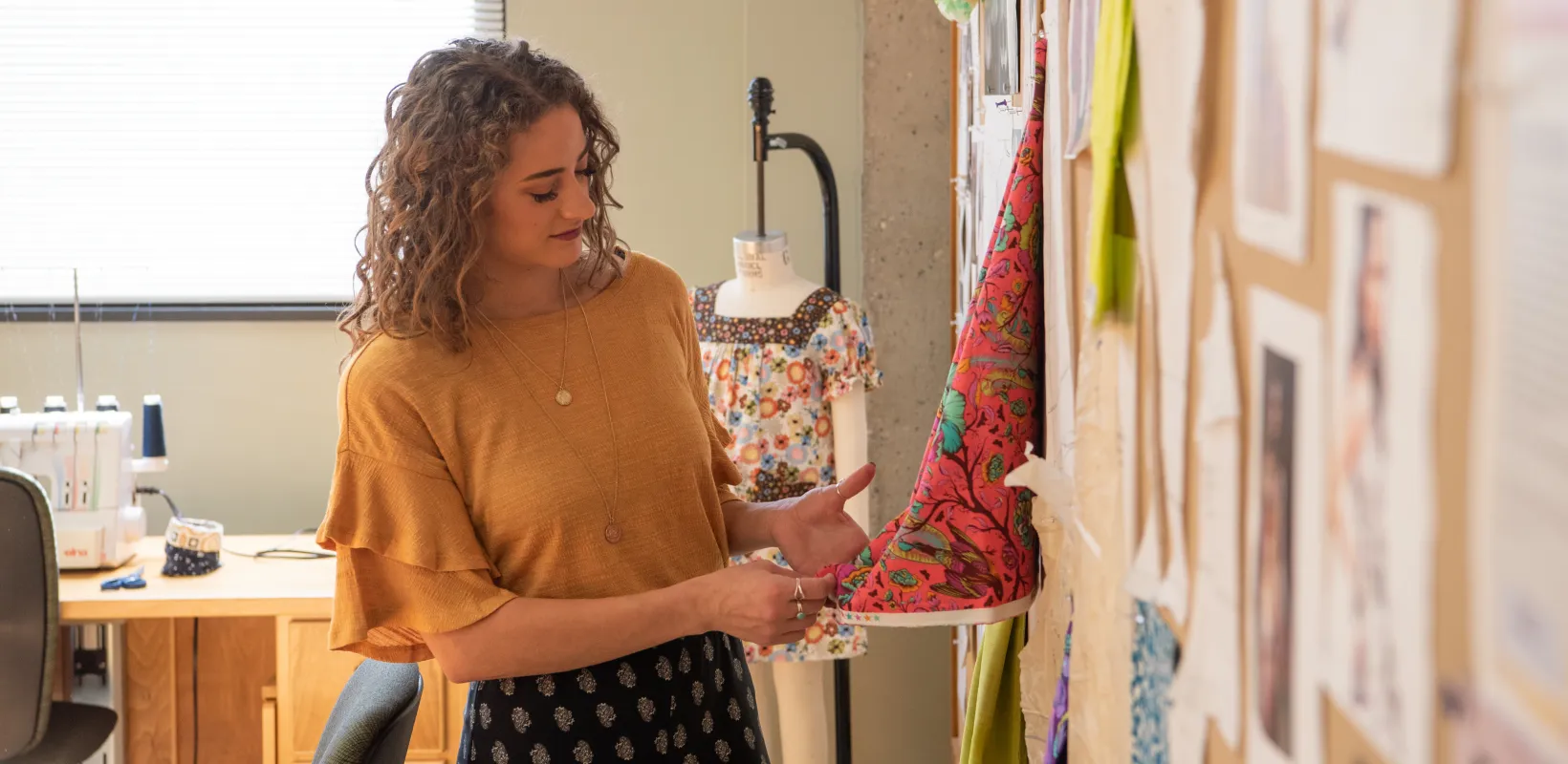 Student working with fabric in design studio.