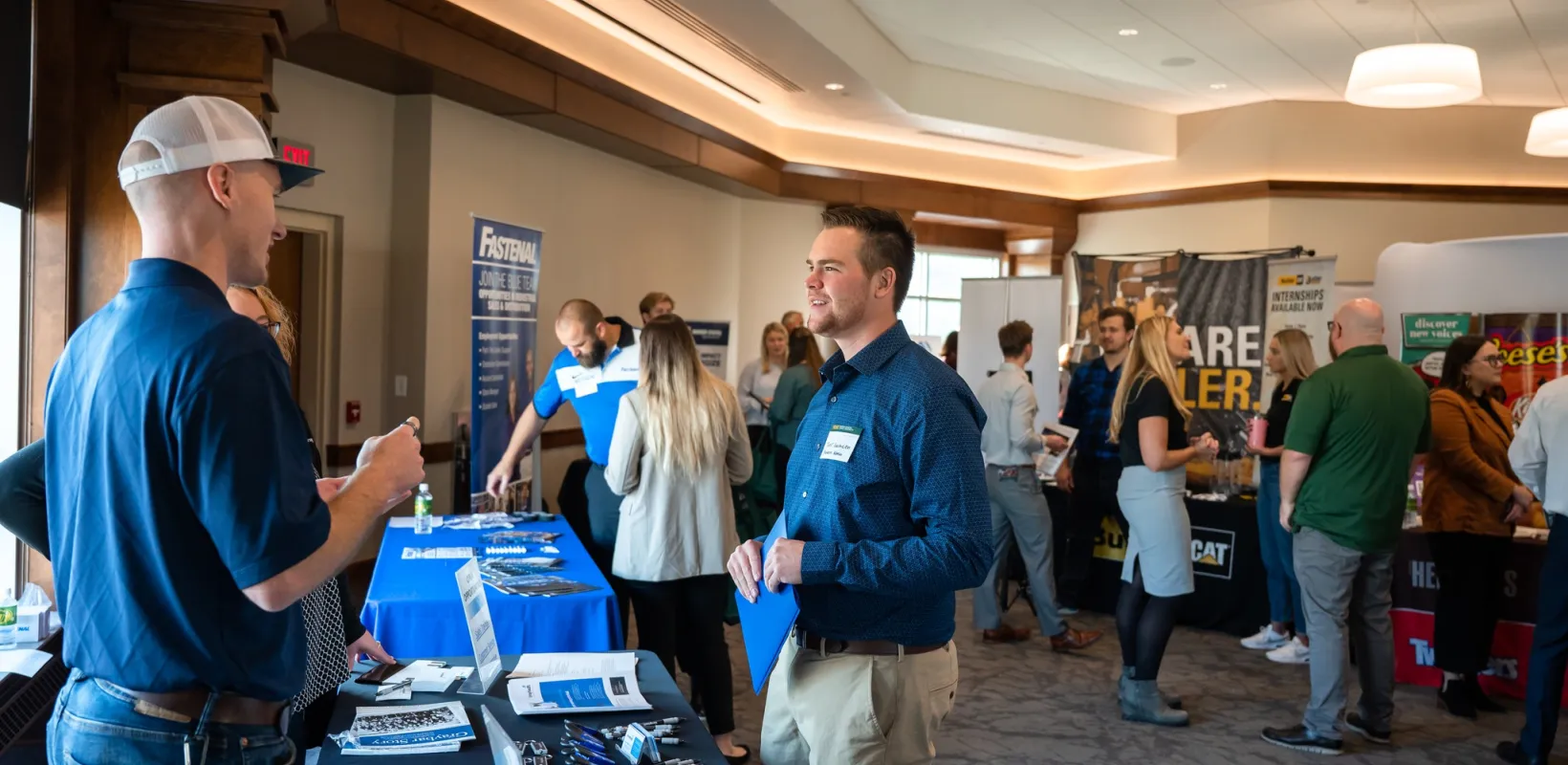 Student talking to a vendor at the sales and marketing fair.