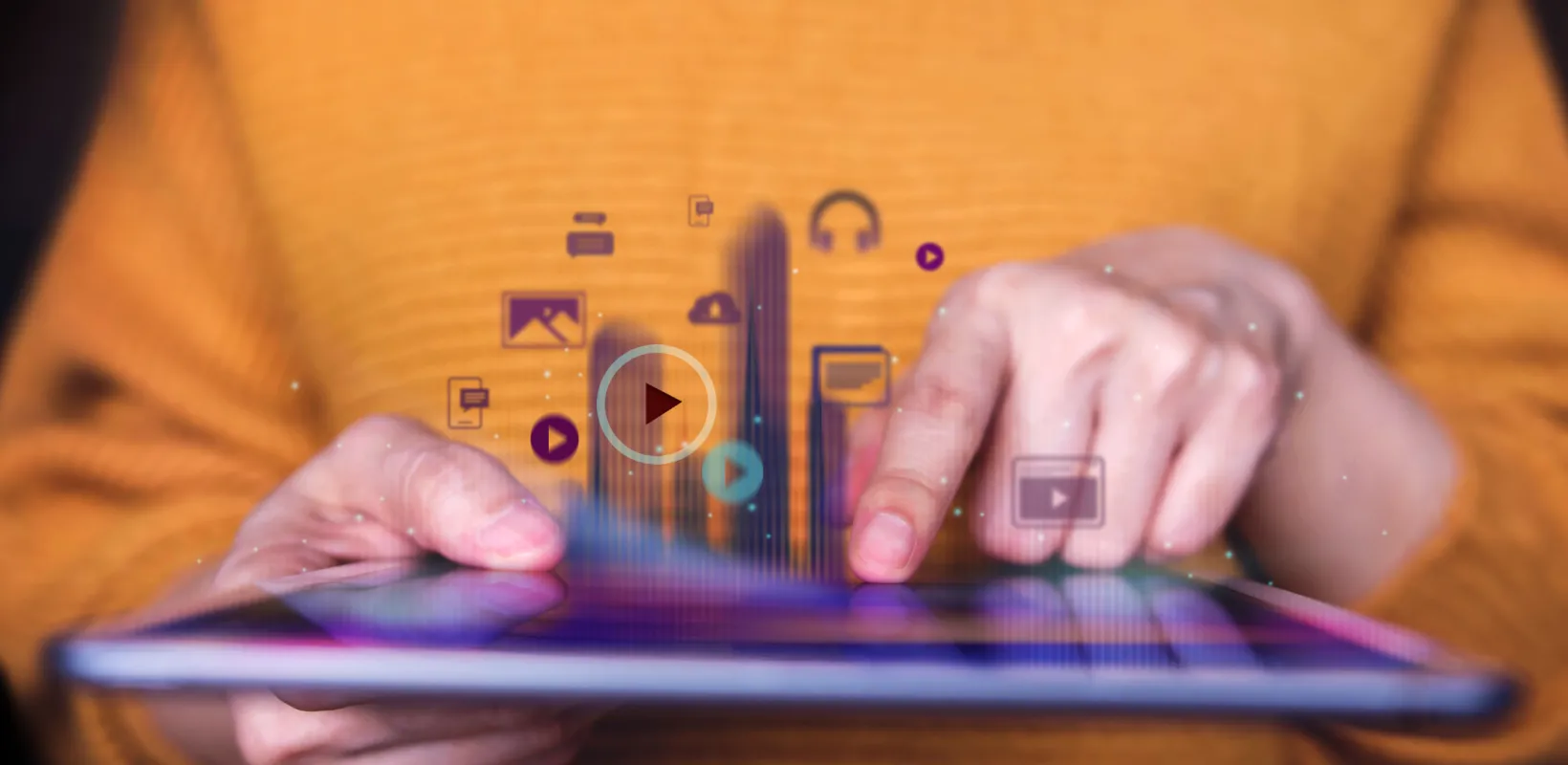 Hands touching an iPad screen.