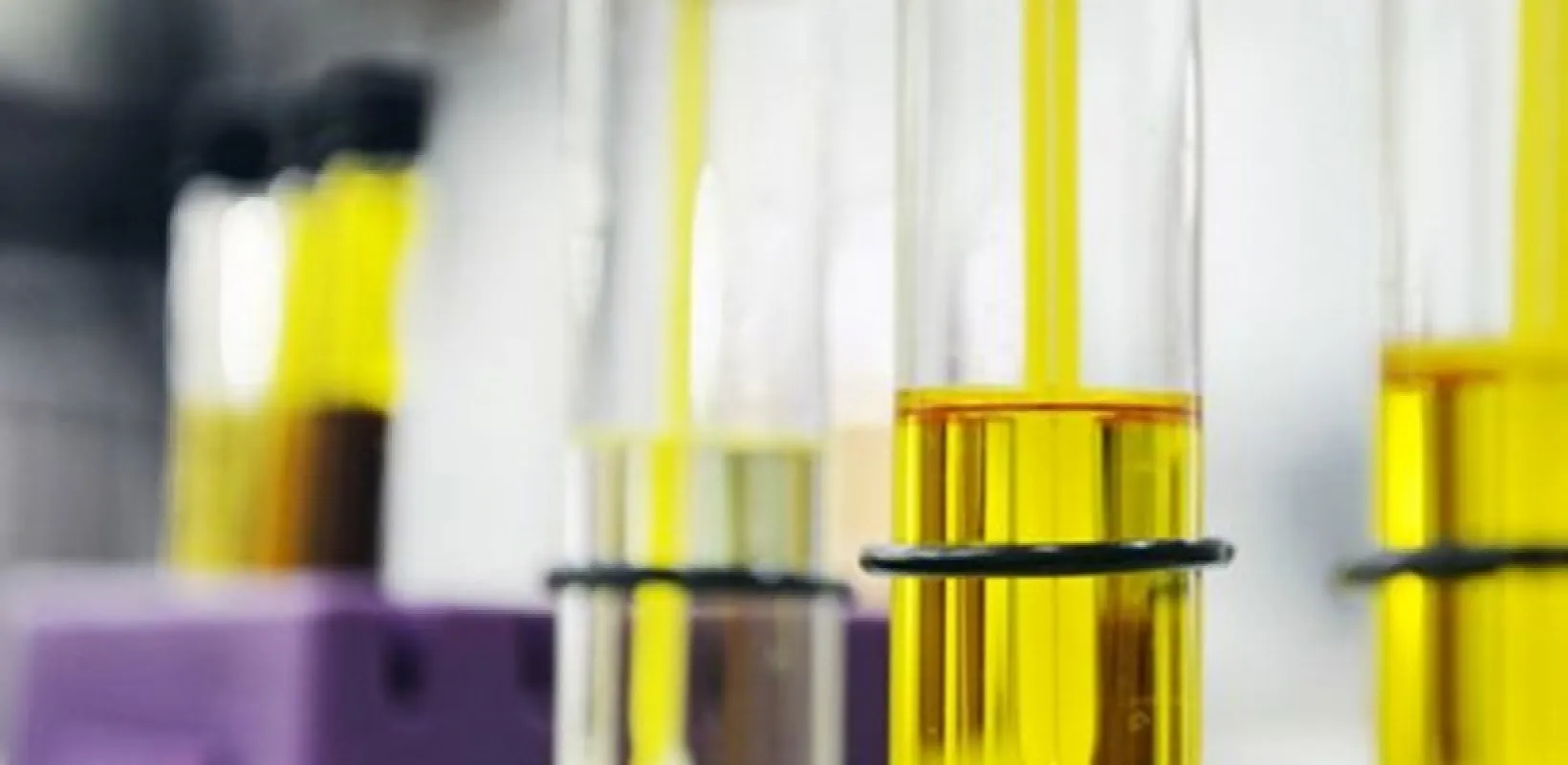 Test tubes containg a yellow liquid. 