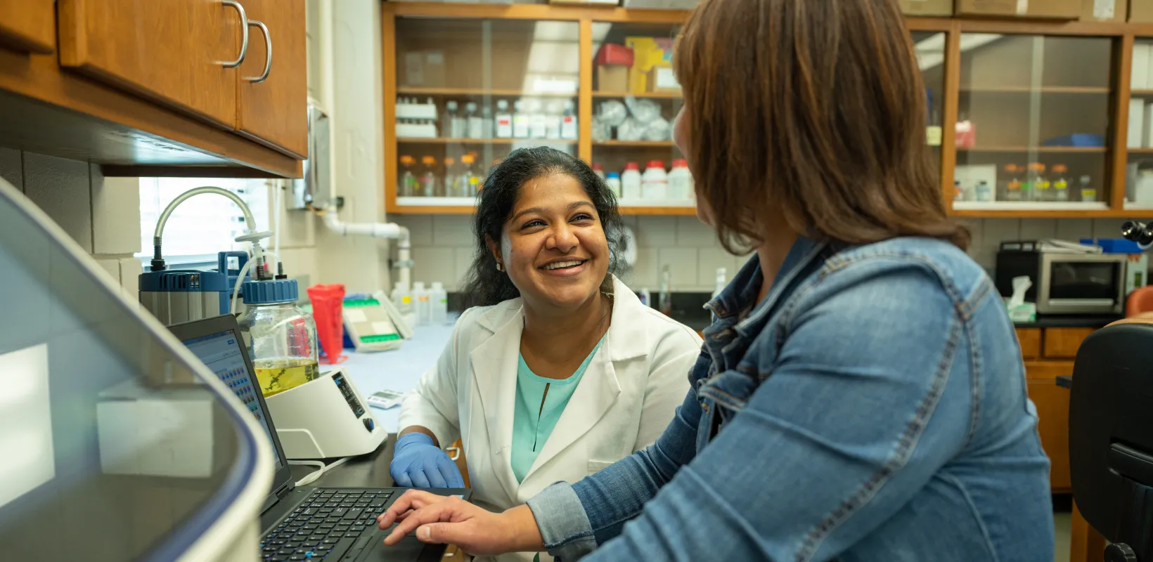 Students discussing research in the lab.