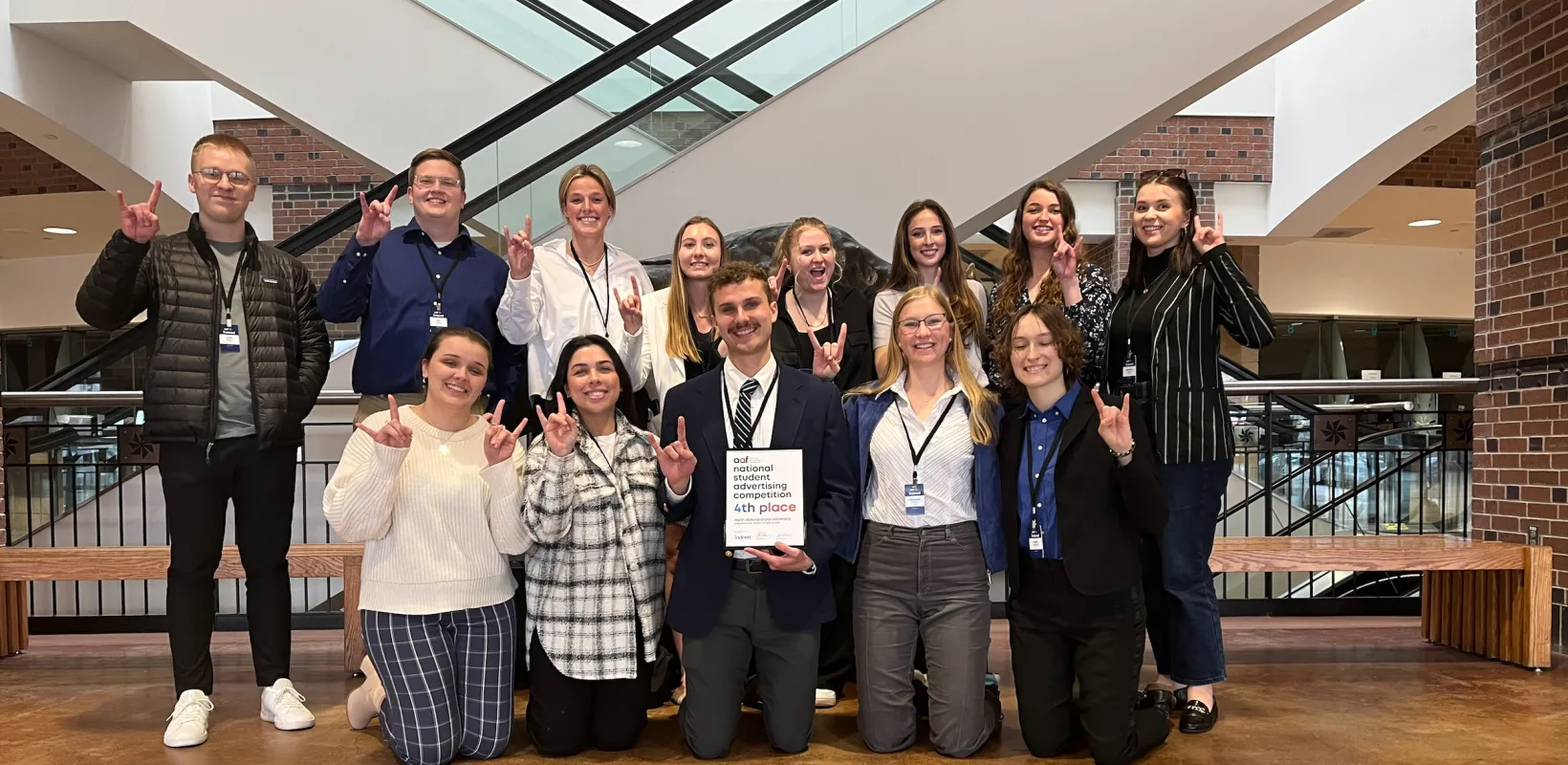 Students smiling confidently at camera.