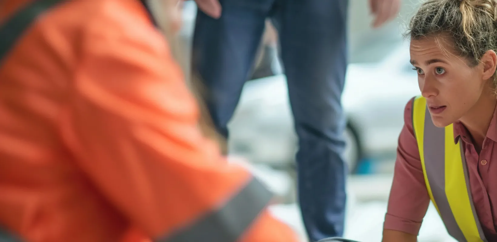 Woman in Emergency Vest with other Emergency Personnel