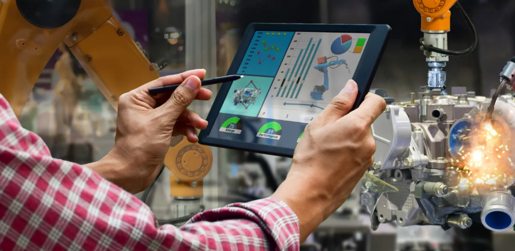 Person holding tablet looking at efficiency charts for a machine process