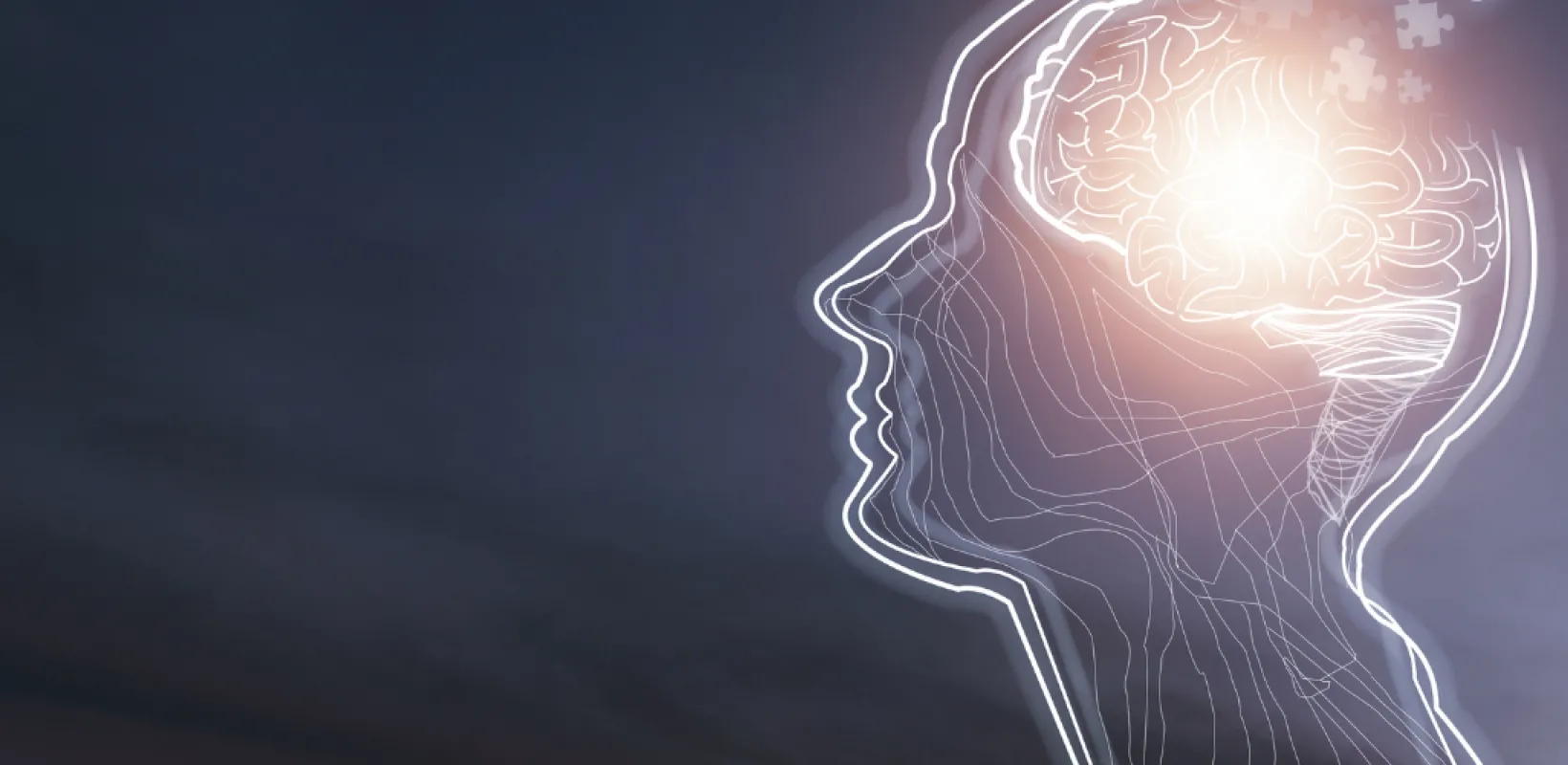 Human brain illuminating puzzle pieces and ideas
