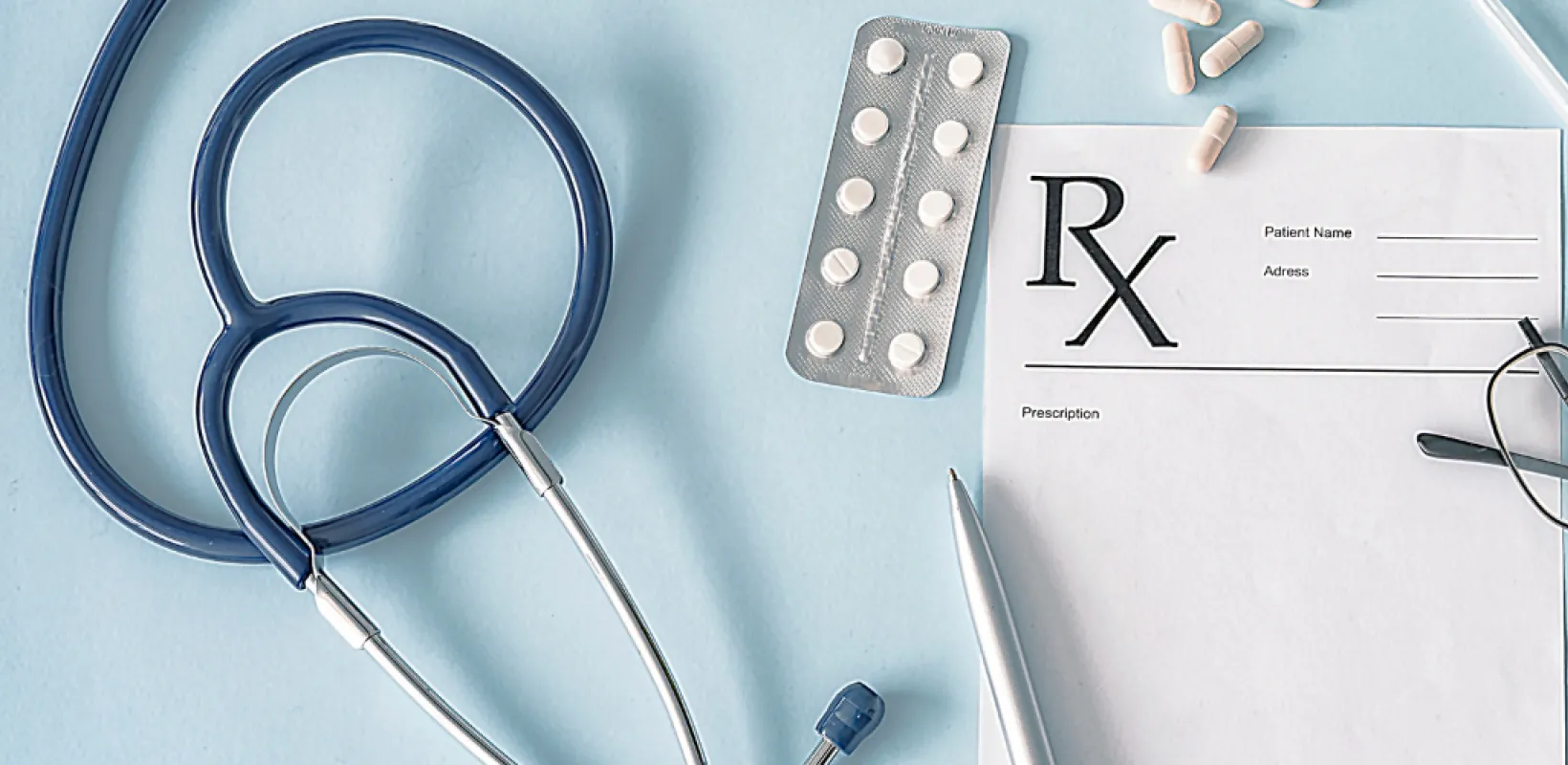 Supplies in Medicine like a stethoscope, mask, eye glasses, plastic gloves, blank prescription 