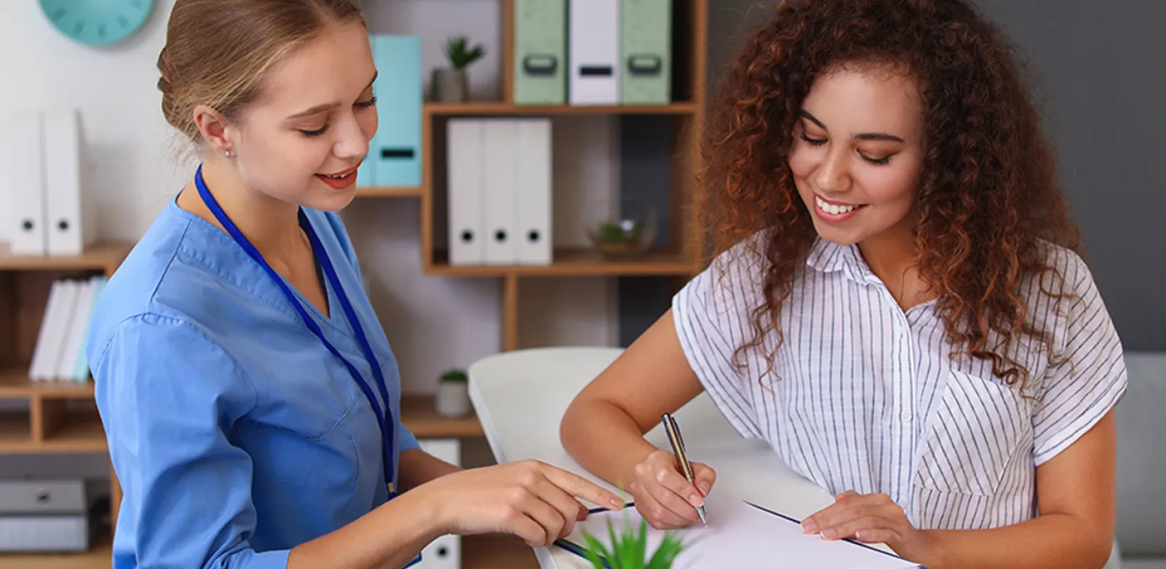 Two medical professionals going over a checklist on a clipboard