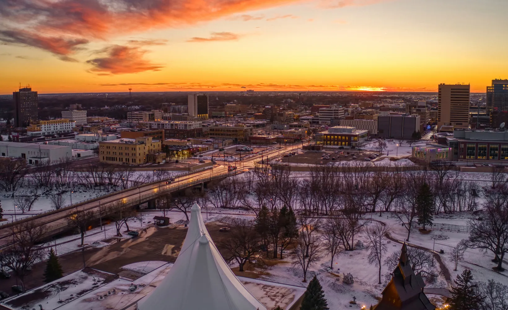 Aerial view of Fargo/Moorhead with sun setting on horizon.