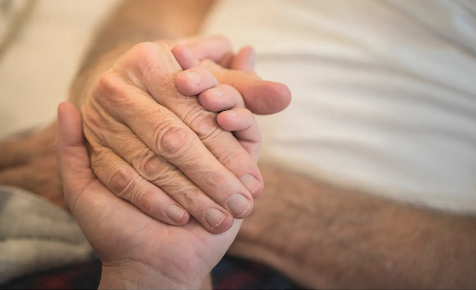 Two hands holding on to each other.