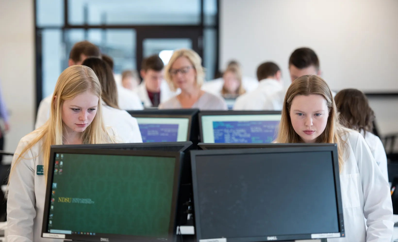 Faculty with students in lab