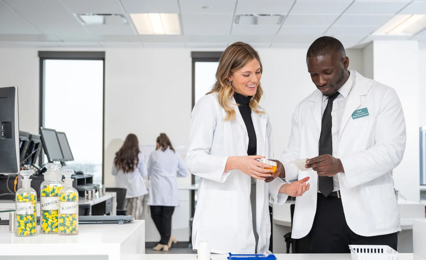 Students in a concept pharmacy lab