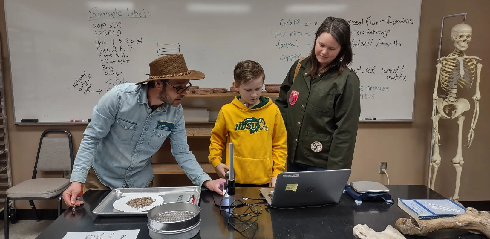 Dr. Creese working with young student at the NDSU Student Day event.