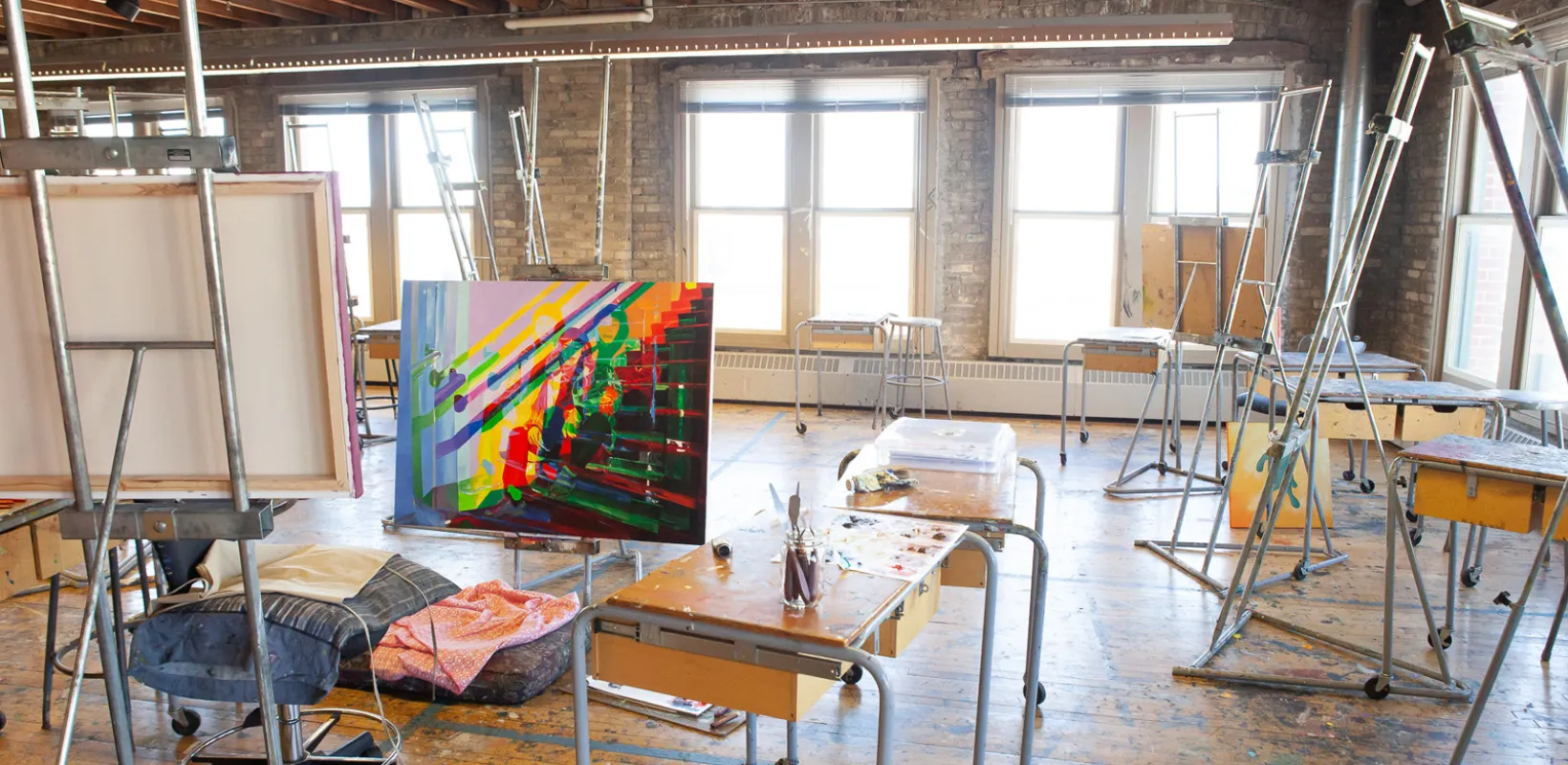 Bright colored art displayed in painting studio.