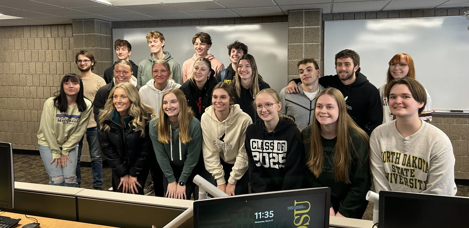 A group of students smiling at camera.