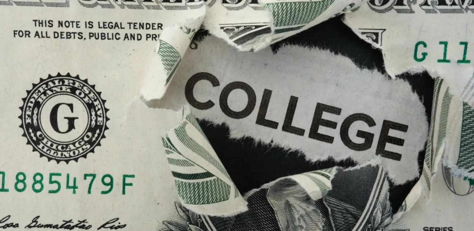 Dollar bill ripped with the word college showing