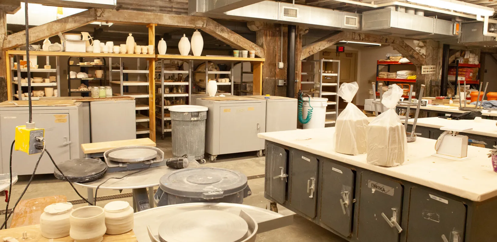 Ceramics Studio with shelves, tables, throwing stations and clay.