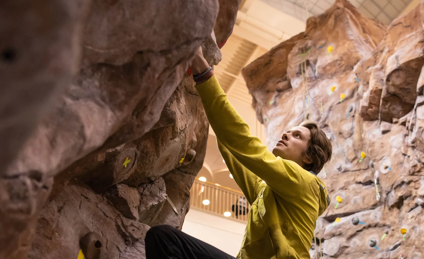 Male student climbing on indoor rock wall