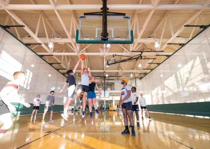 Male students playing pick up basketball game at NDSU Wellness Center