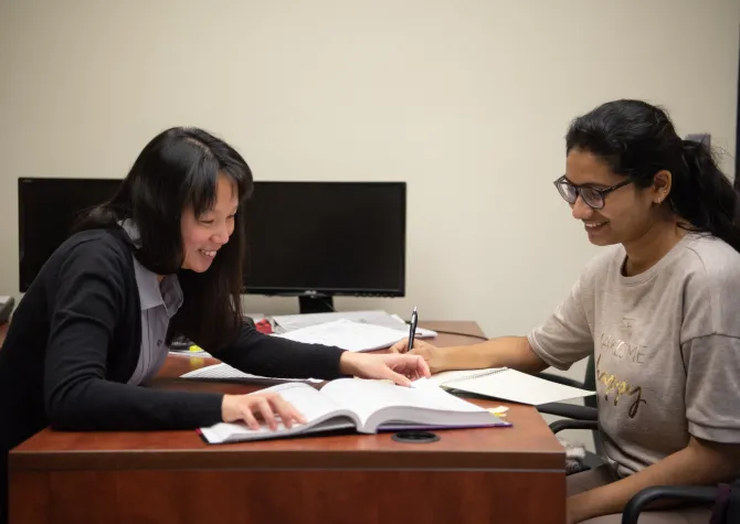 faculty member works with student