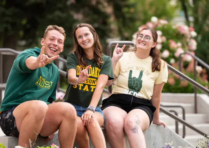 three students on steps