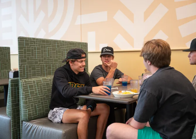 Students in a booth having lunch at West Dining Center