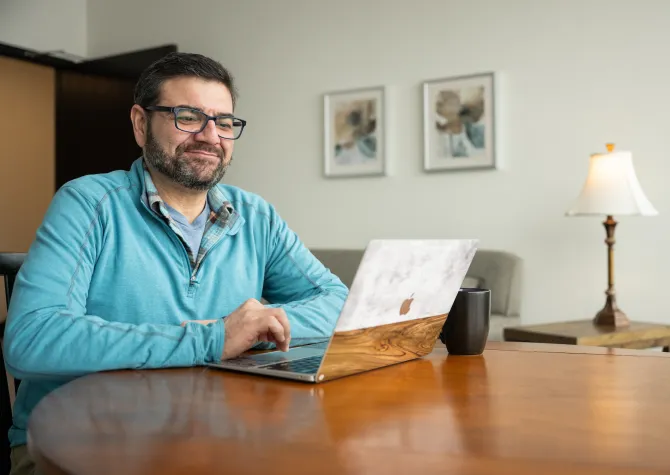 student working on laptop from home office