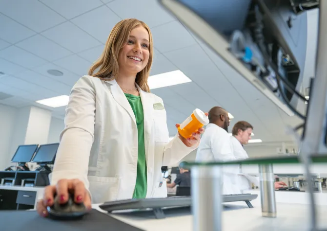 Pharmacy student filling a prescription